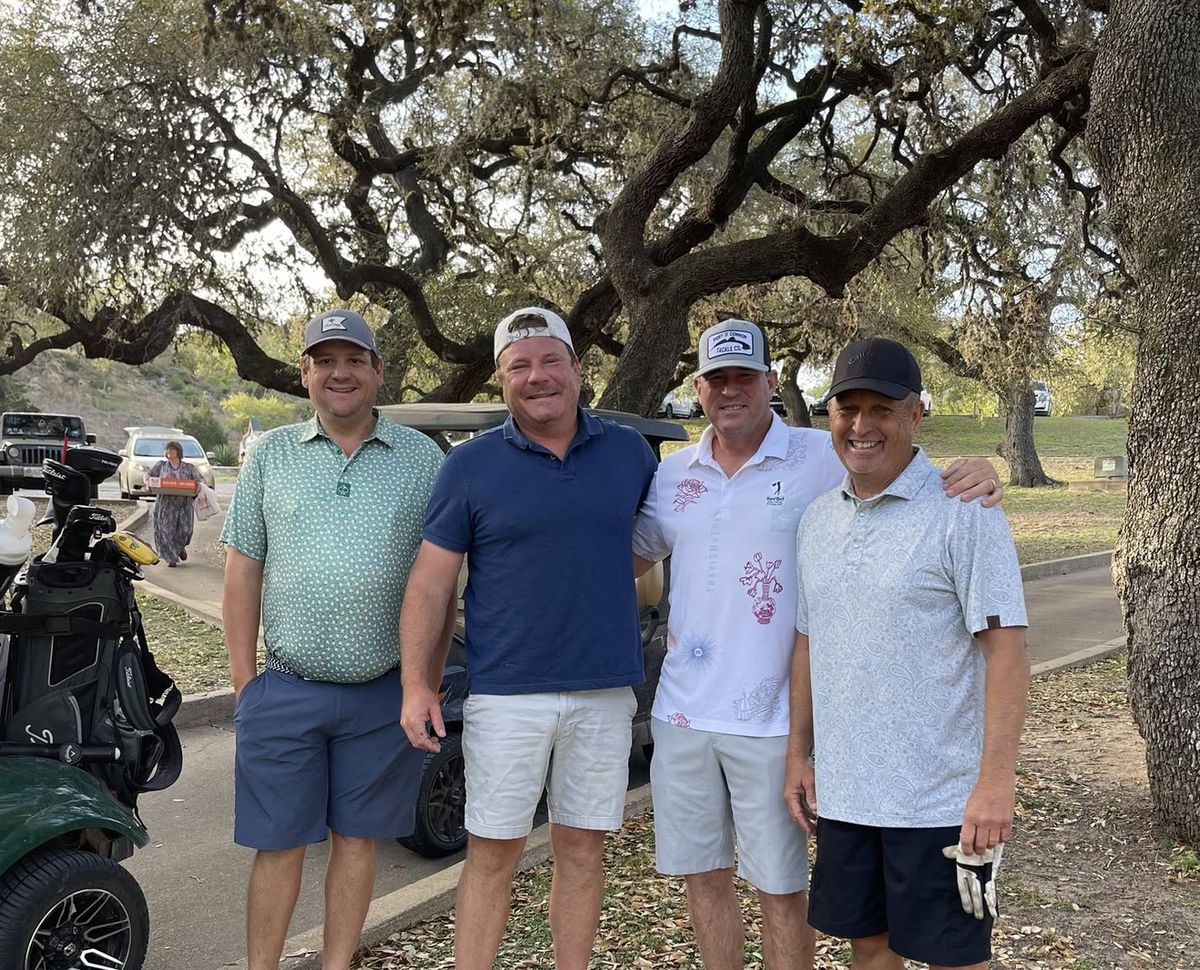 Golf tournament foursome under the oak trees